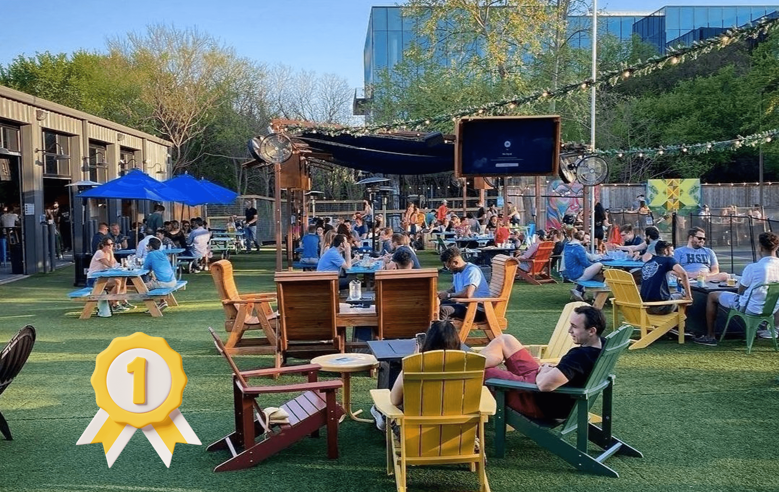 green meadow with wooden tables and people relaxing